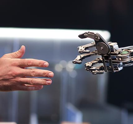 Person reaching for a robotic hand